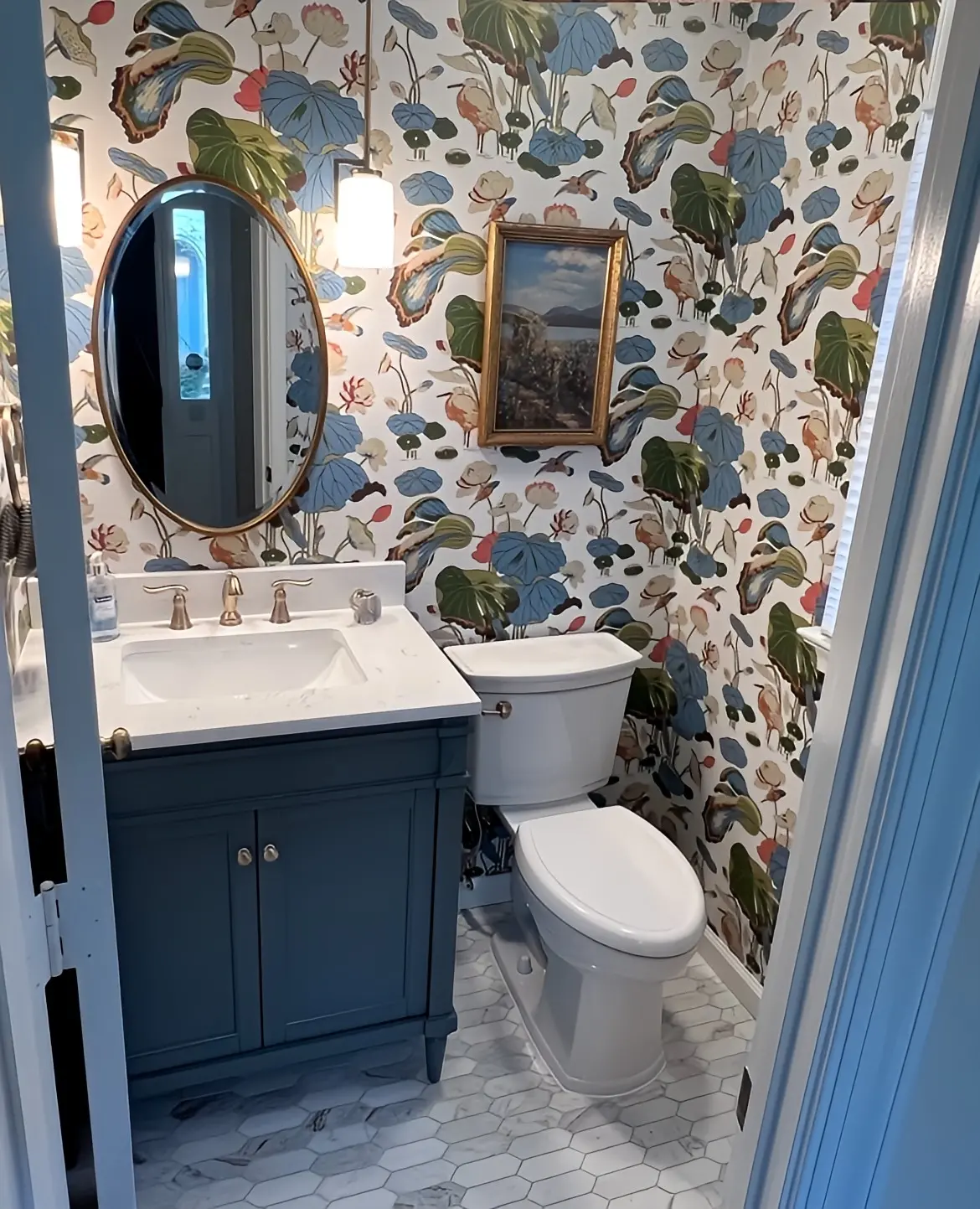 a bathroom with floral wallpaper and a toilet
