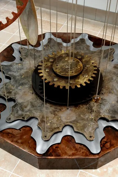 a mechanical clock with gears and a pendulum