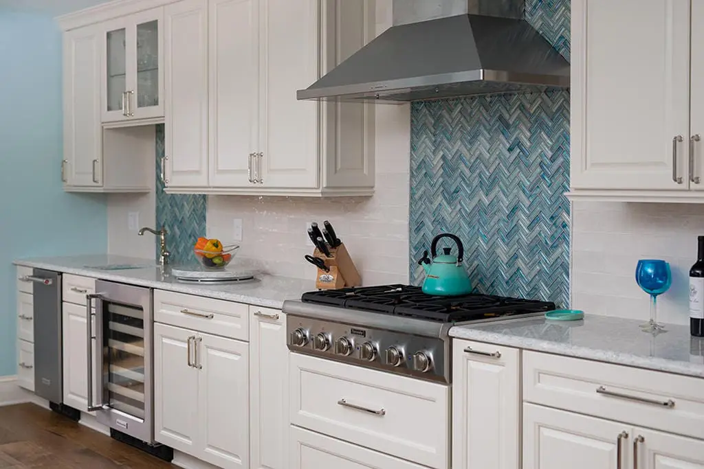 a kitchen with white cabinets and white countertops