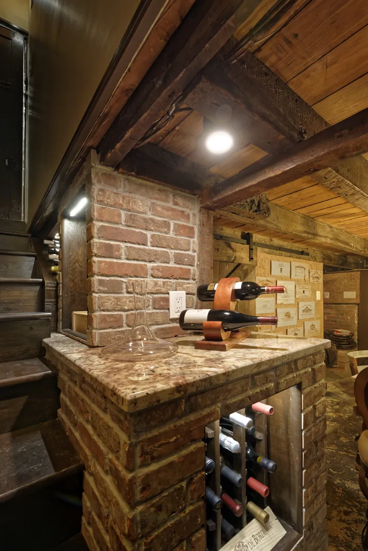 a wine rack with bottles on a marble counter