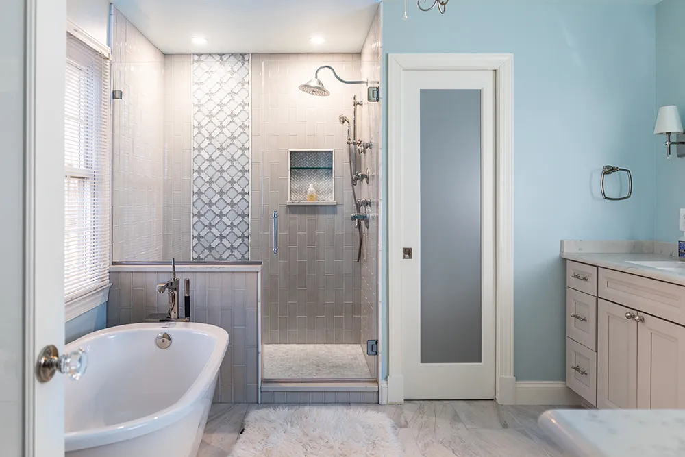 a bathroom with a large mirror and blue cabinets