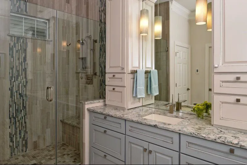 a bathroom with a glass shower and sink
