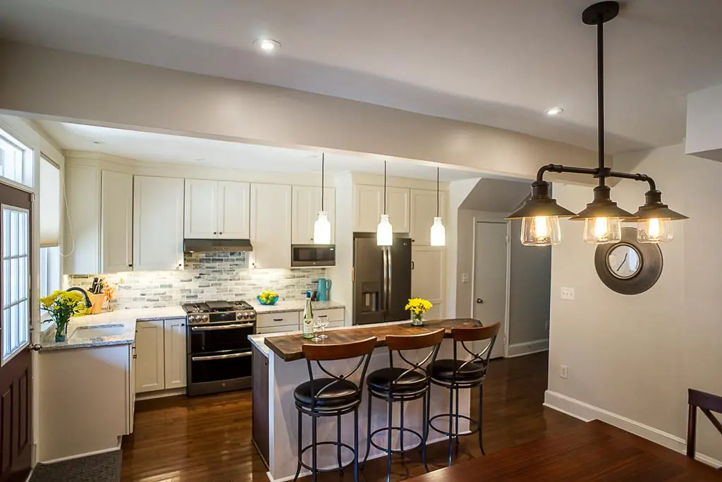 a kitchen with a bar and a refrigerator