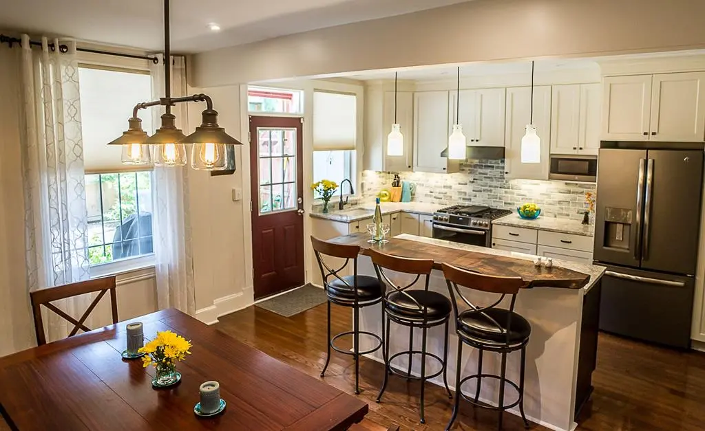 a kitchen with a table and stools
