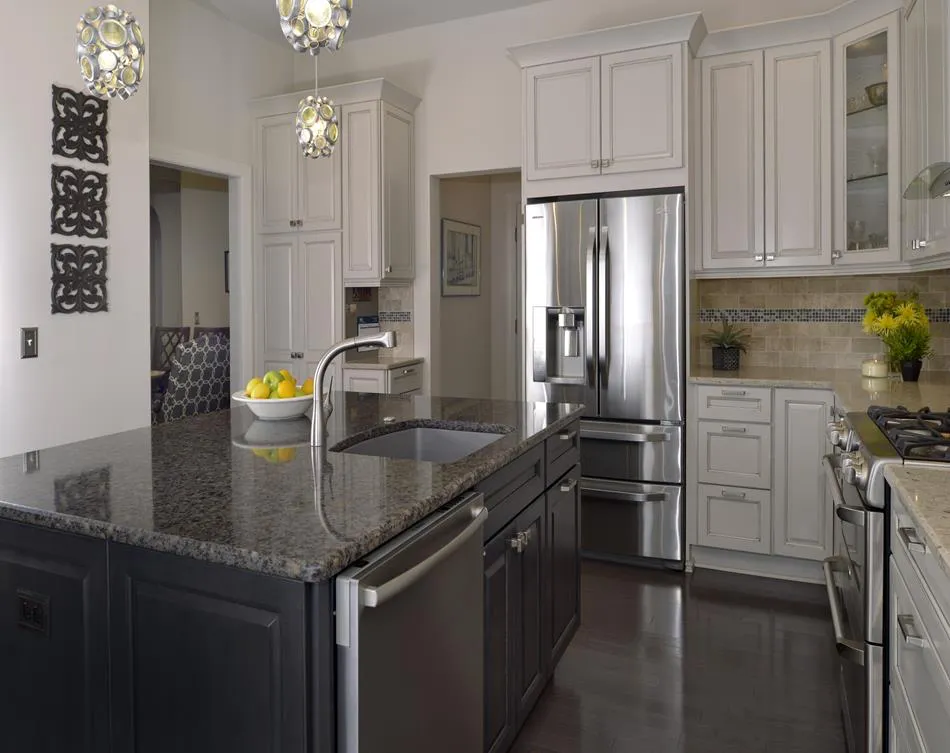a kitchen with a granite island and stainless steel appliances