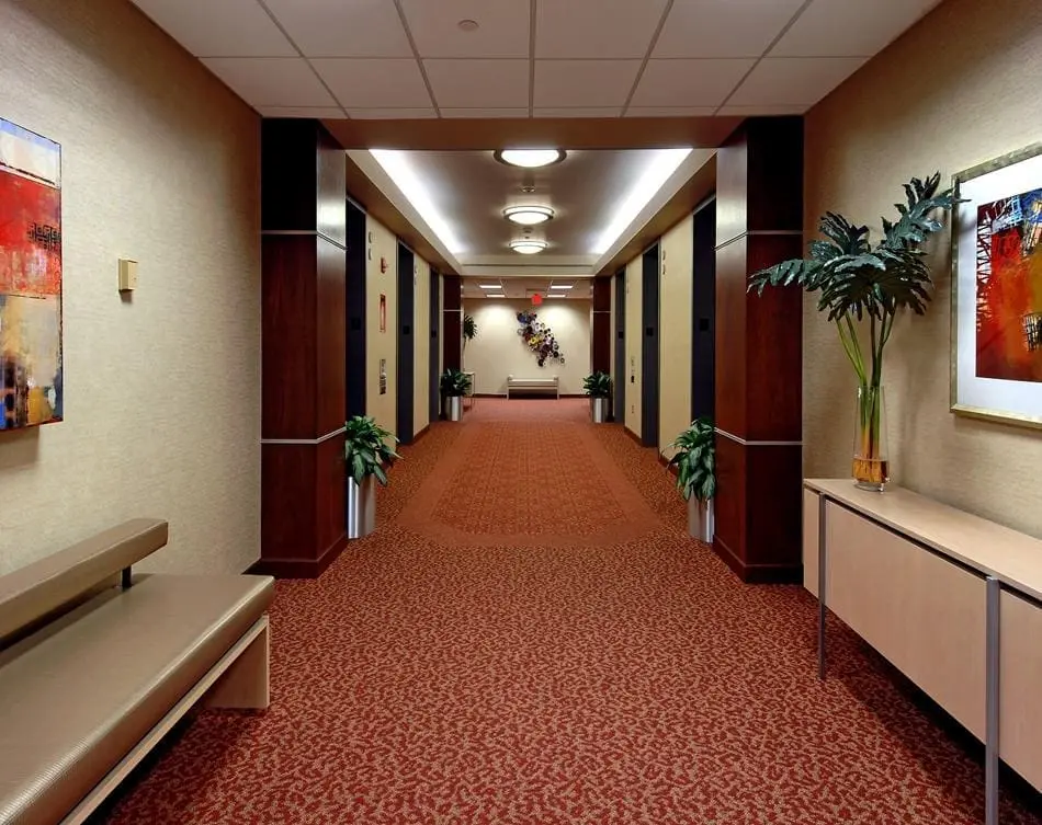 a hallway with a bench and plants