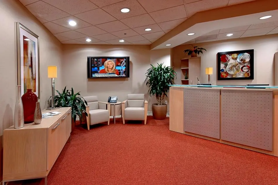 a room with a tv and a desk