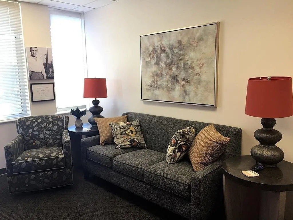 a couch and lamp in a room