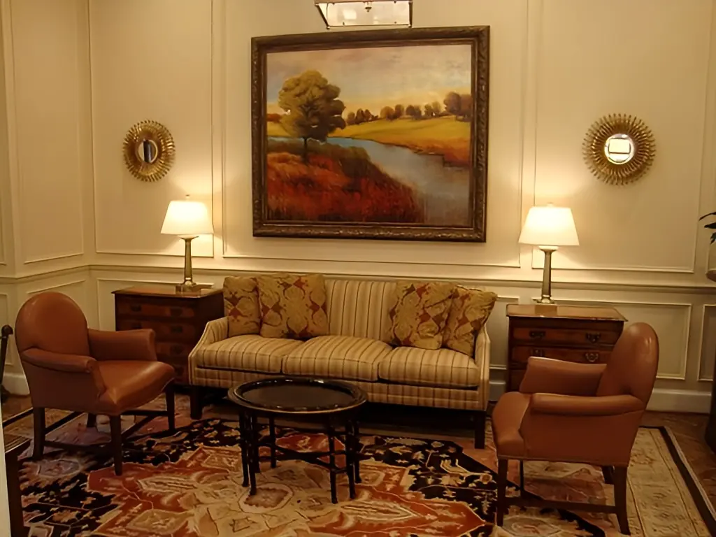 a room with a couch and a painting on the wall