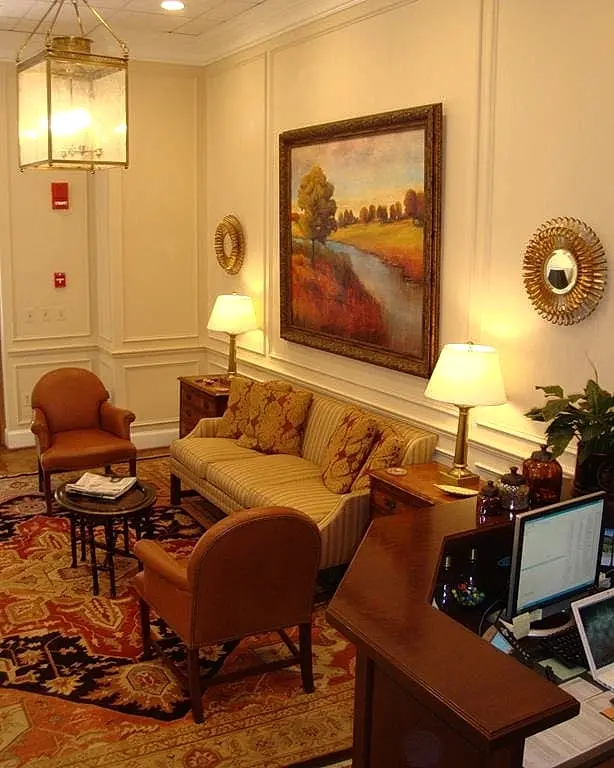 a living room with a painting on the wall