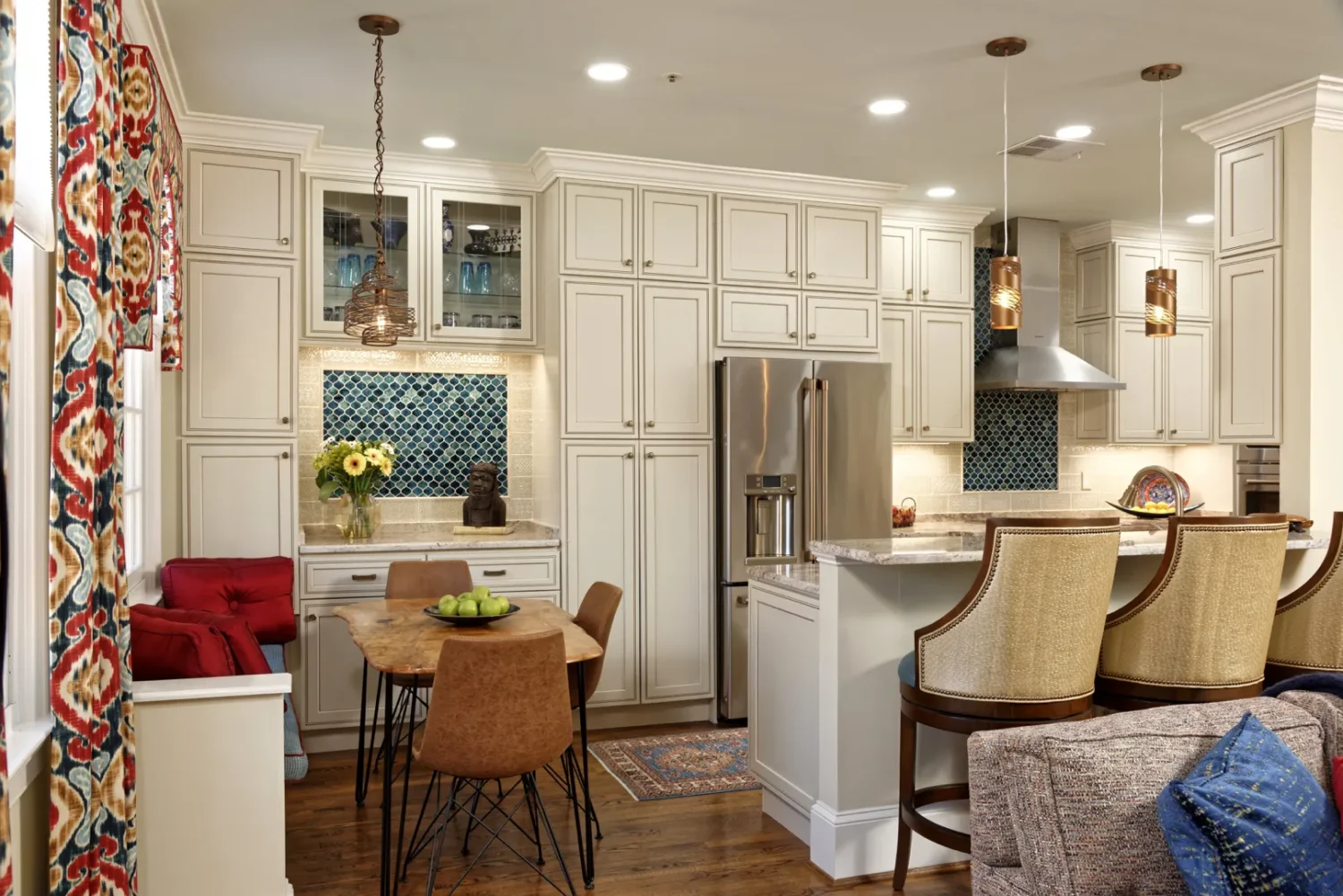 a kitchen with white cabinets and a table