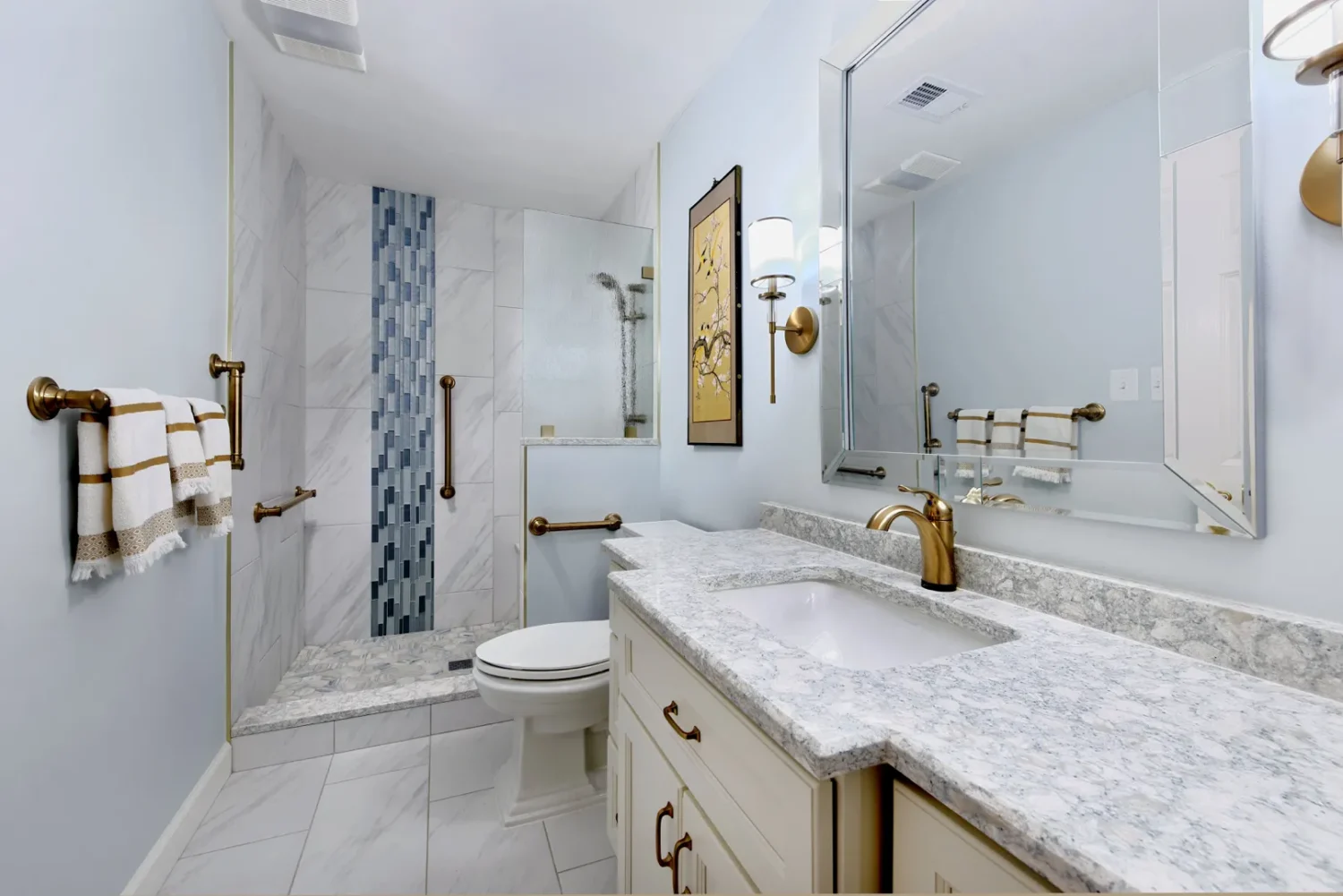 a bathroom with marble countertop and a shower