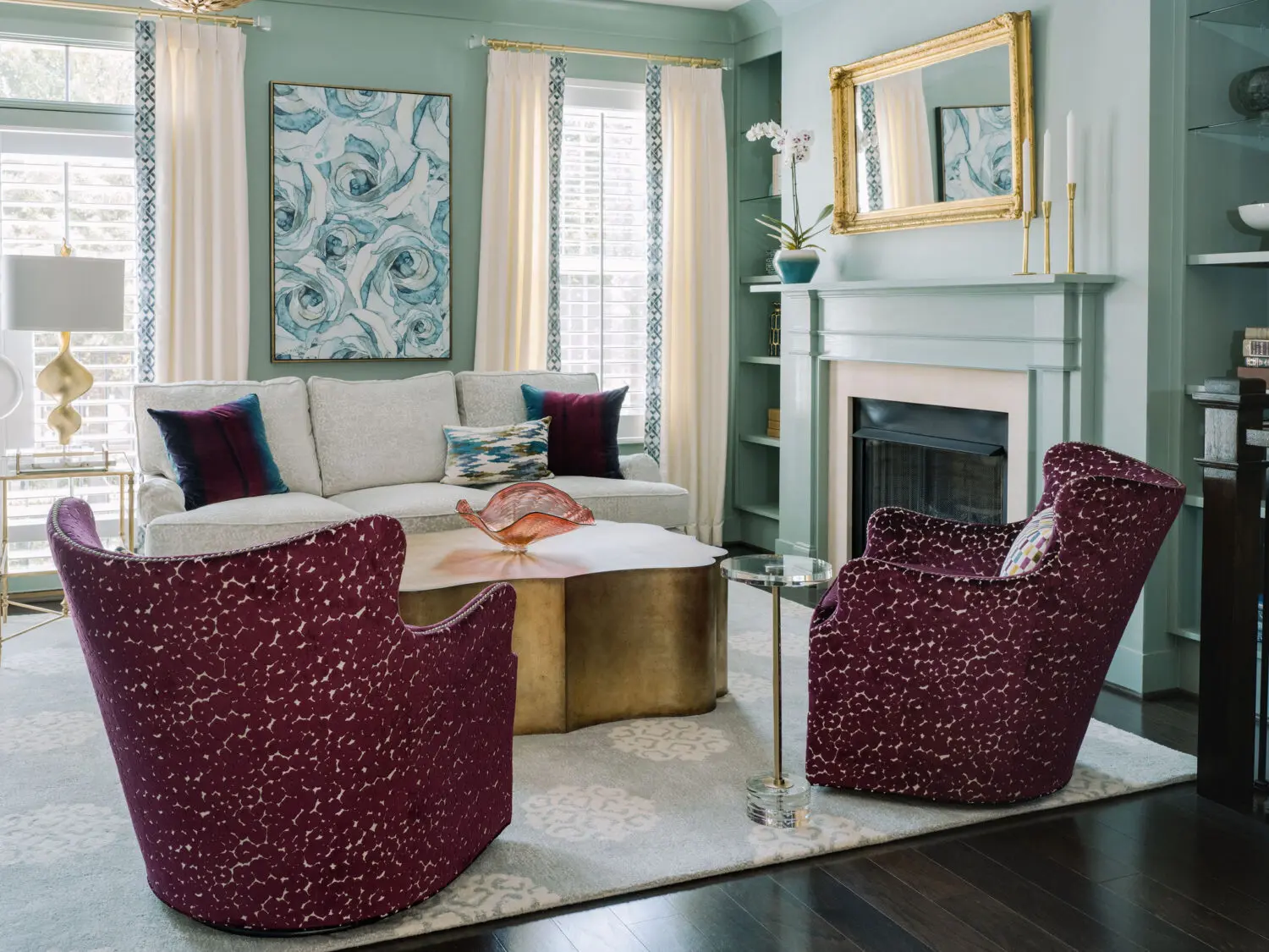 a living room with a fireplace and chairs