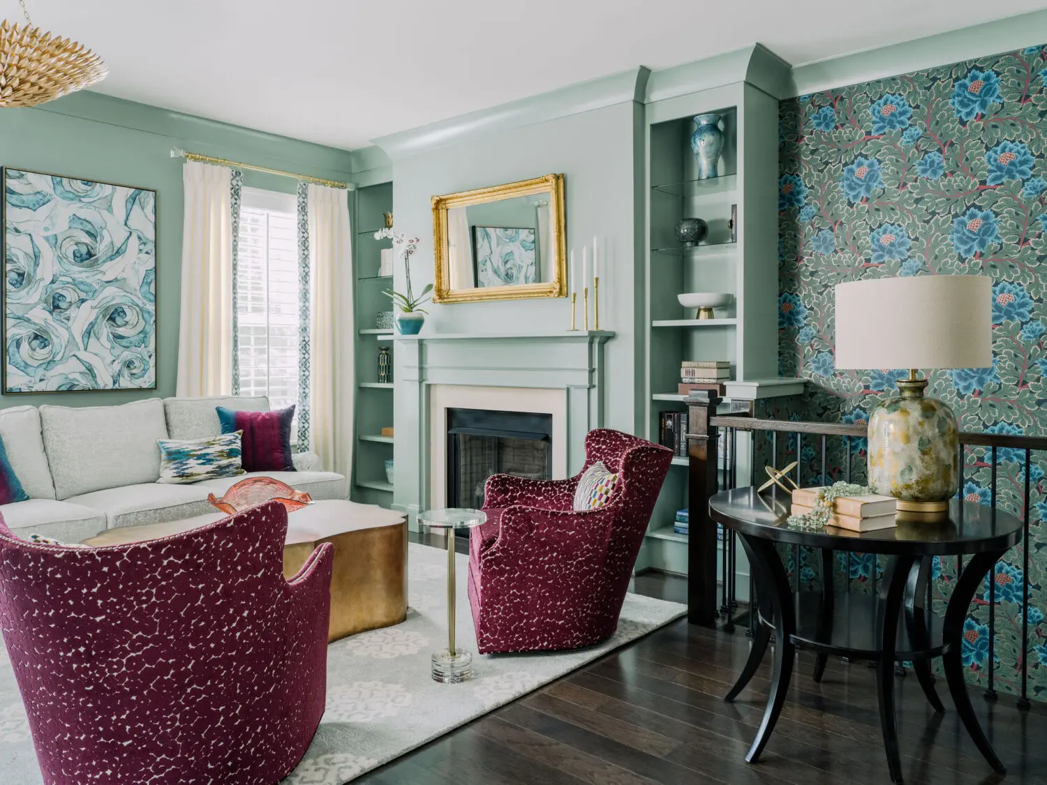 a living room with a fireplace and chairs